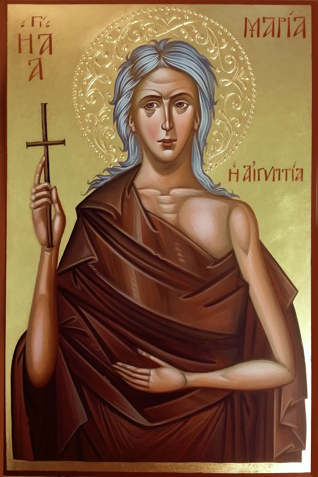 Hand-painted Byzantine icon of Saint Mary of Egypt showing her holding a cross with a gold haloed background and Greek inscriptions