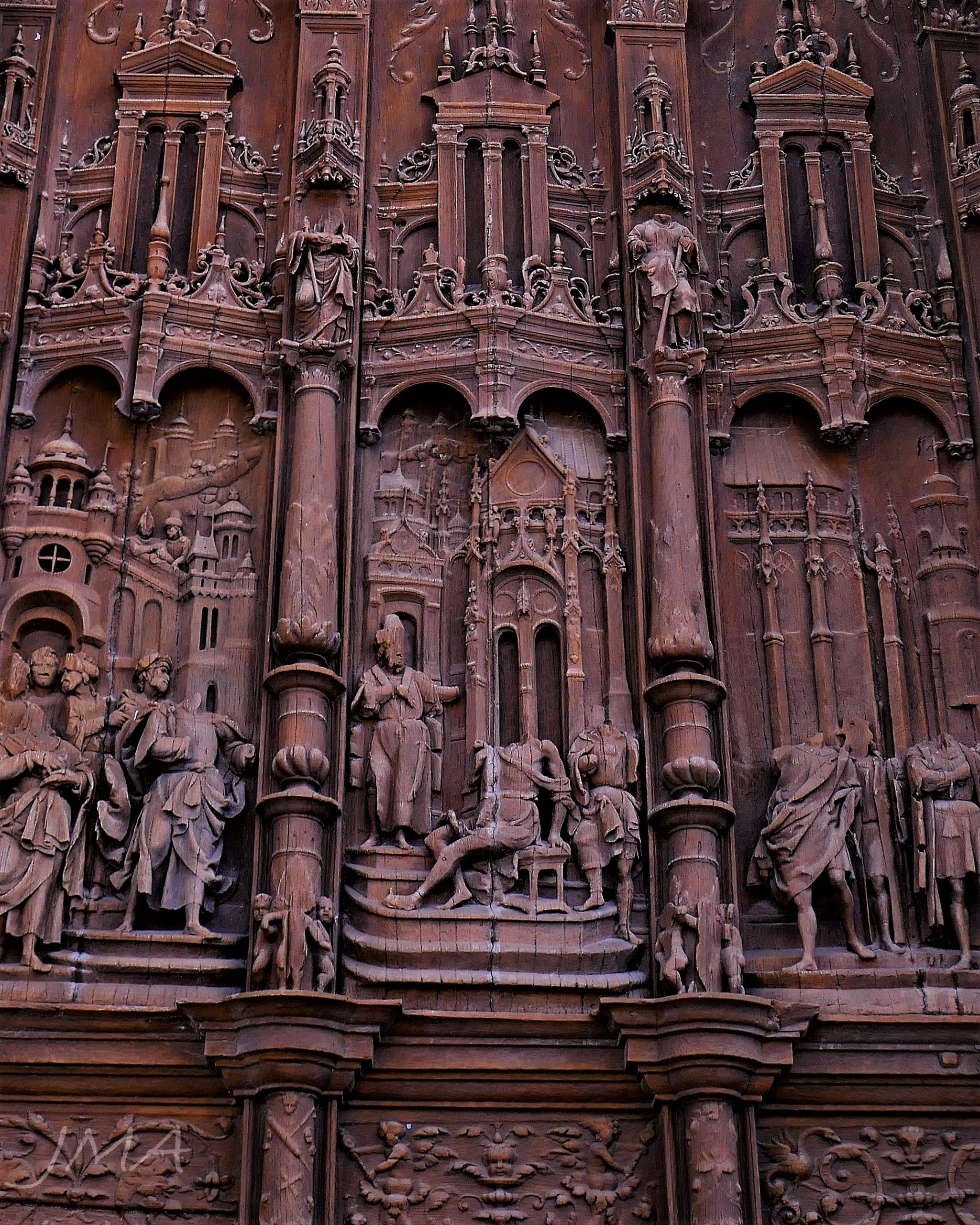 Ornate wood carving depicting possible vandalism on religious figures